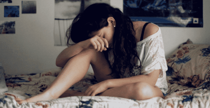 woman feeling guilty on bed