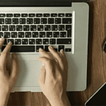 fingers typing on computer