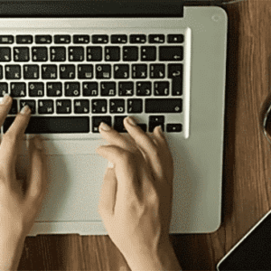 fingers typing on computer